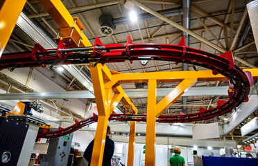 Intricate Overhead Conveyor System with Red and Yellow Frame Offering Efficient Material Handling Solutions