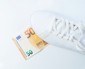 Sneaker on 50 euro bill as symbol of lifestyle and spending