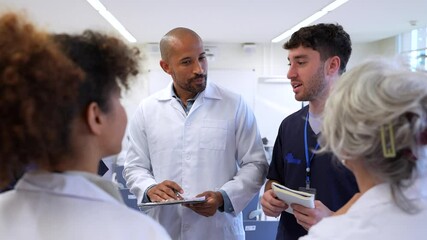 Medical team discussing patient cases in hospital meeting - Powered by Adobe