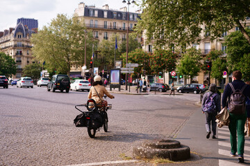Cyclist Traveling Through a Busy Urban Street Intersection in a European City..