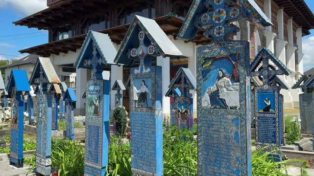 Colorful tombstones depicting scenes from people's lives stand in the Merry Cemetery of Sapanta, Romania