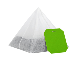 Pyramid-shaped tea bag with a green tag.