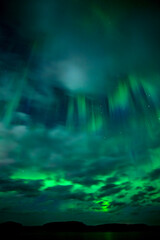 Moon light lake with a dancing northern lights in Farnebofjarden national park in north of Sweden.