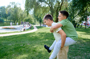 Two Boys Enjoying Piggyback Rides in a Sunny Park Setting