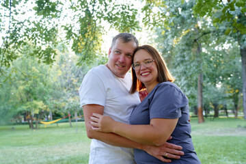 Happy Couple Enjoying Quality Time in a Green Outdoor Setting..