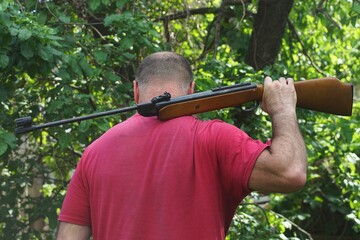 one black powerful pneumatic dangerous iron with wooden butt industrial with long barrel rifle in...