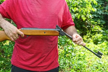 one black powerful pneumatic dangerous iron with wooden butt industrial with long barrel rifle in...