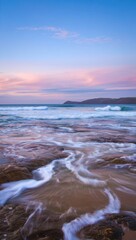 Obraz premium Serene coastal sunset waves crashing rocks