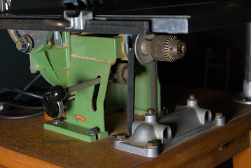 A vintage green and silver workshop machine, showcasing robust construction and intricate mechanical details. Ideal for crafting and DIY projects.
