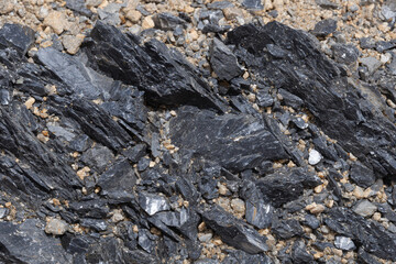 Close-Up of Rough Black Rock Surface Texture Dark, Natural Stone Background