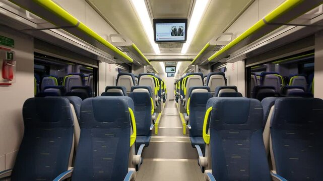 Interior of a Modern Train Car: Inside a contemporary train carriage, rows of neatly arranged seats invite passengers to experience the pleasure of train travel