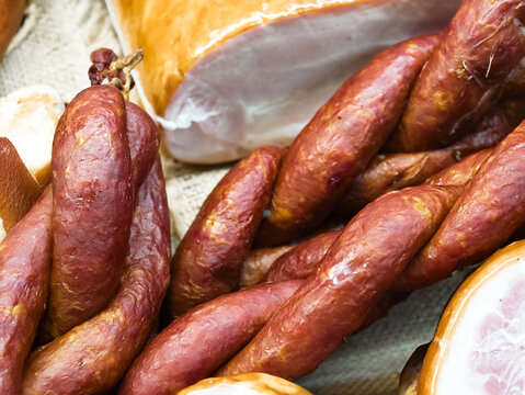 Savory delights of artisan smoked meats at a vibrant local market during a sunny afternoon