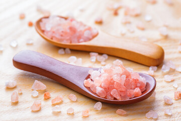 Closeup view of wooden spoons with Himalayan salt crystals