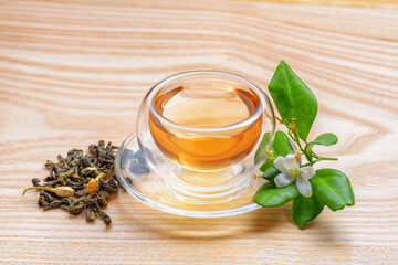 Jasmine green tea in clear cup on wooden table