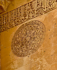 Elaborate carved patterns and details on the majestic gate of the Sultan Isa Medrese, Madrasa,...