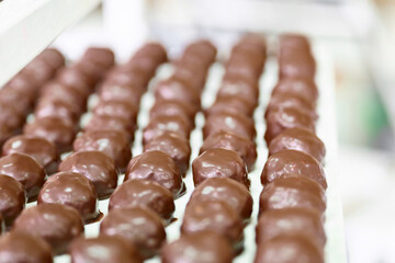Delicious chocolate-coated grillage ready for packaging in a confectionery workshop