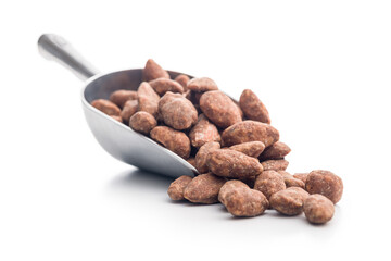 Almond nuts coated in sugar and honey in scoop isolated on white background.