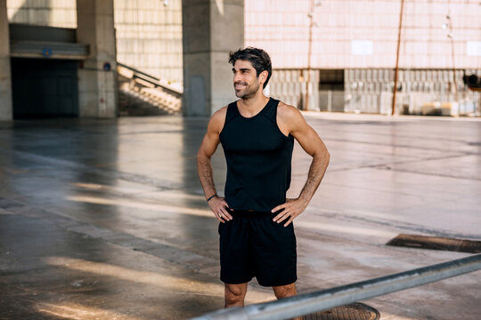 Hispanic athlete takes a break after an intense training session at an urban sports facility