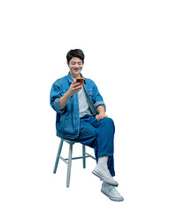Full body image of young asian man sitting on chair , using phone and posing on PNG background