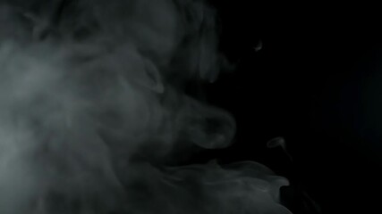 White smoke plumes float against a black background - Powered by Adobe