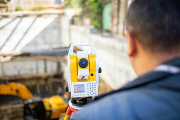 Surveying equipment in use during construction project at urban site in daylight