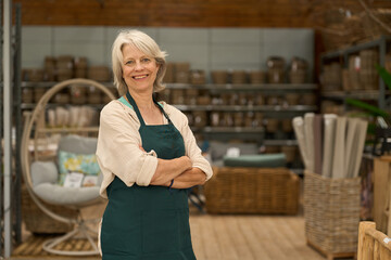 Portrait of confident senior saleswoman smiling in furniture store