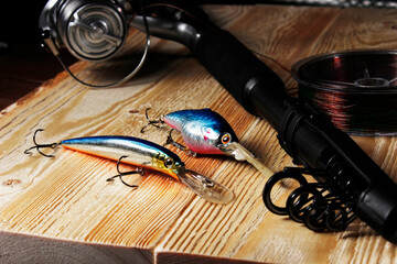 fishing lures, baits,  wobblers, rods and reels, objects for sport fishing on the background of an...