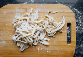 Fresh homemade noodles on a wooden board