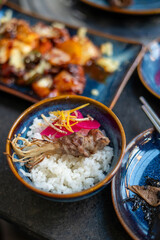 Rice with savory meat and chopsticks on a dining table