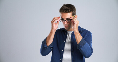 Man, glasses and optometry in studio for testing, vision or adjusting to new lens for sight....