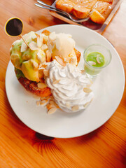 Bread menu topped with ice cream and whipped cream
