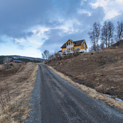 Panorama with yellow single house on beach of North Atlantic. colored hotel,  wooden holiday home...
