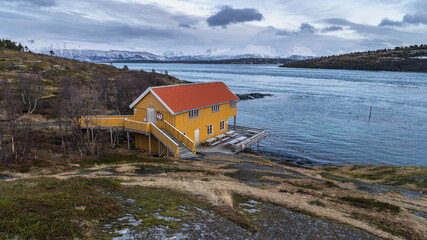 Panorama with yellow single house on beach of North Atlantic. colored hotel,  wooden holiday home...