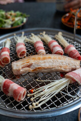 A delicious plate filled with meat and mushrooms sizzling on a grill