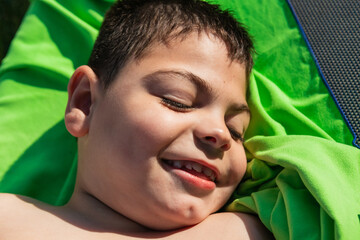 Portrait of smiling child with cerebral palsy relaxing by pool