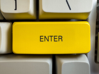 Large yellow Enter button on mechanical white keyboard for programmers with gray shades and red...