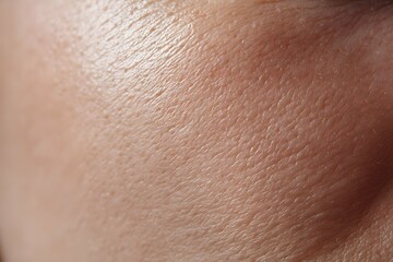 Radiant skin glows with soft shadows amidst natural pores and smooth contours.