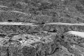 Ancient weathered stone steps showcasing the rough texture and intricate natural patterns formed...