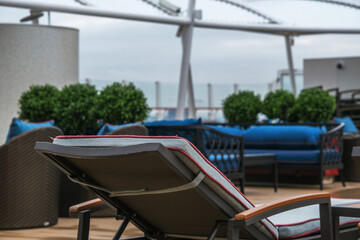 Fototapeta premium Outdoor whirlpool jacuzzi and private sun deck onboard modern luxury cruiseship cruise ship ocean liner with turquoise water, elegant rattan loungers and deck chairs for suite guests passengers