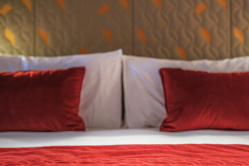 Luxurious mini suite stateroom cabin room onboard luxury cruise ship cruiseship ocean liner with bedroom and living area in red and creme with wood in modern Art Deco interior design