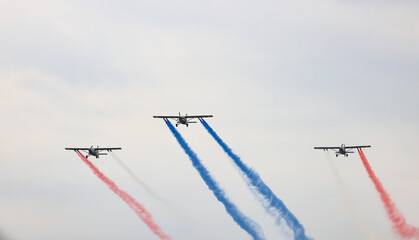 AU-23 Peacemaker Armed gunship, counter-insurgency, utility transport aircraft on formations with colorful smokes venting from the plane.
