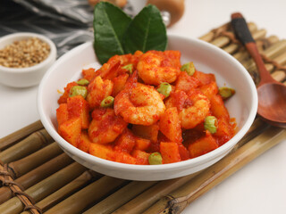 Stir fried shrimp and potato cooked in chilies in white bowl