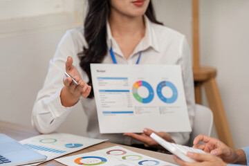 Collaborative Financial Discussion. Businesswoman presenting budget insights to her colleague.
