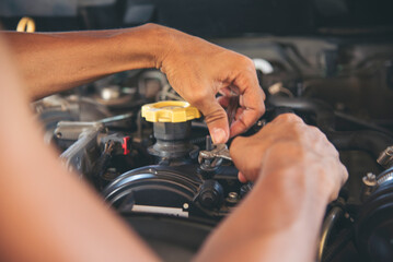 Close up Man hands fixing Car machinery vehicle mechanical service. Mechanic man hands repairing car auto repair shop. open vehicle hood checking up auto mobile. Vehicle Car maintenance engineer.