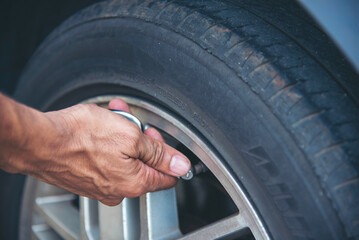 Mechanic man hands checking car tires outdoor on site service auto garage for automotive mobile...