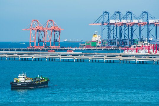 Logistic shipping quay boat Engineering crane depot at logistic export terminal control. Warehouse freight background container yard loading quayside harbor port. Logistics seascape shipping portal