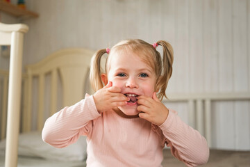 Little Girl joking sticking tongue out with silly expression. Child making face. Funny foolishness...
