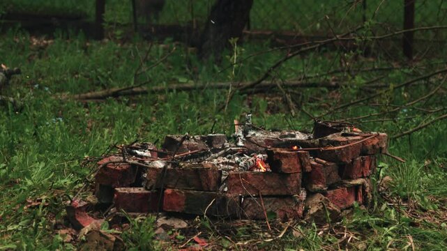 a smoldering campfire in the countryside. slow motion
