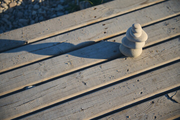 Pebble Stack on Wooden Deck in Natural Outdoors Environment