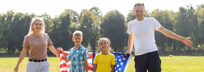 Happy family with flags of USA outdoors